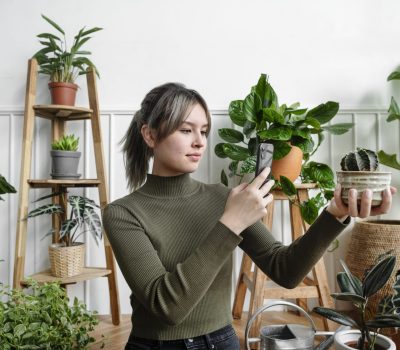 Woman taking a snapshot of her plant for social media